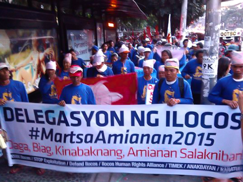 Ilocos farmers--whose produce suffer from unfair competition from imported agricultural products--travel to Manila to join APEC protests. Photo by Amianan Salakniban.